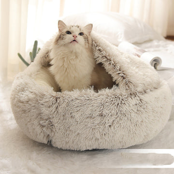 Fluffy cat in a round plush pet bed, providing warmth and comfort. Perfect for dogs and cats in winter. Designed by Pet La'Fleur.